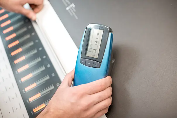 AV engineer measuring room acoustics with a sound level meter in an empty conference room