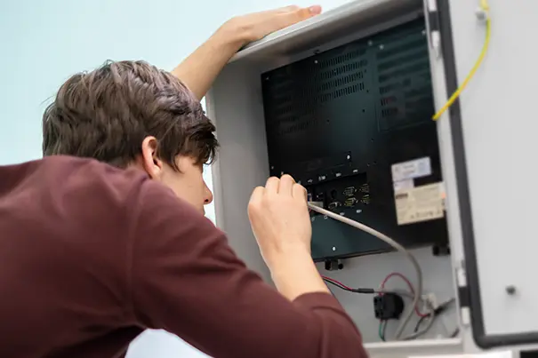 An AV engineer commissioning and testing a control system during installation