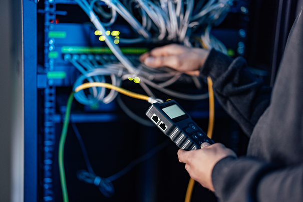 AV technician testing and calibrating a control system before commissioning