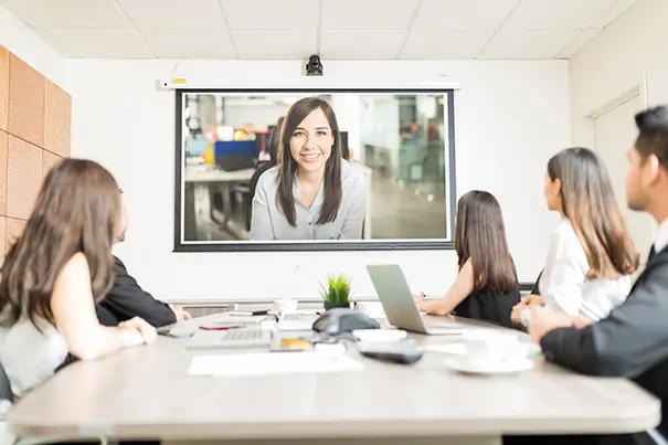 Conferencing camera tracking speakers in a large meeting room