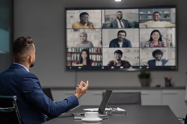 Executives in a modern boardroom using an intuitive video conferencing system during a meeting