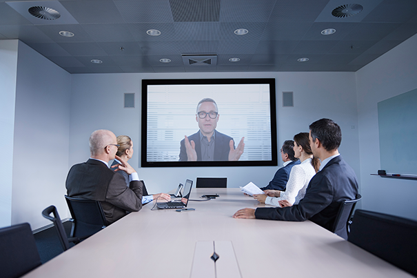 Modern Indian corporate boardroom with a large display running a hybrid video call