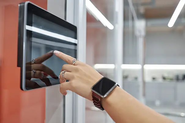 Close-up of a one-touch meeting room control panel used to start a video call instantly
