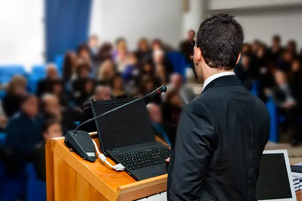 Presenter sharing content from a laptop to large screens in a conference room