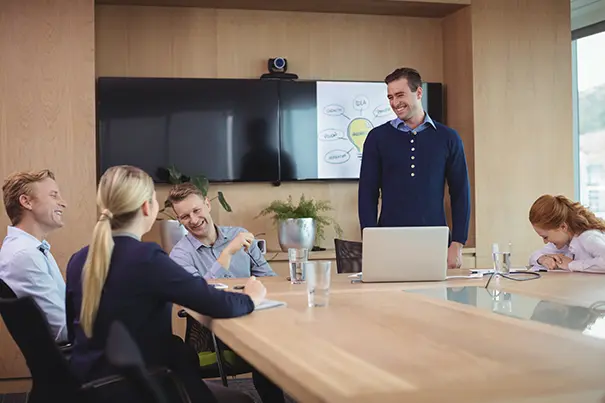 Front-of-room camera at eye level framing participants in a boardroom